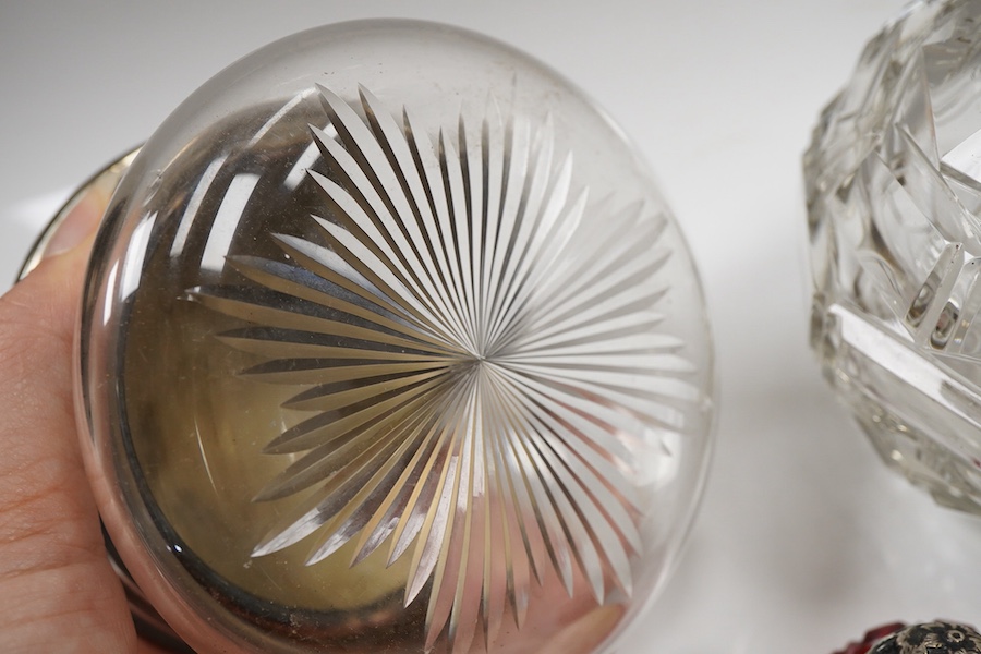 Two George V silver mounted glass powder jars, Henry Matthews, Birmingham, 1923, two silver mounted cut glass scent bottles including ruby flash and a white metal overlaid blue glass scent bottle.